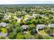 The property is situated in a verdant neighborhood with expansive lawns and tree-lined streets at 315 Sweet Bay Ave, New Smyrna Beach, FL 32168