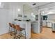 Stylish bar area with seating, mirrored backsplash, and direct access to the kitchen at 315 Sweet Bay Ave, New Smyrna Beach, FL 32168