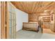 Basement bedroom features rustic wood paneled walls, a wet bar, and a bed at 315 Sweet Bay Ave, New Smyrna Beach, FL 32168