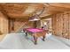 Finished basement with rustic wood walls, a pool table, and access to the kitchen area at 315 Sweet Bay Ave, New Smyrna Beach, FL 32168