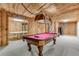 Large finished basement with rustic wood paneled walls, a pool table, and access to other rooms at 315 Sweet Bay Ave, New Smyrna Beach, FL 32168