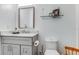 Modern bathroom with a vanity, framed mirror, decor, and toilet at 315 Sweet Bay Ave, New Smyrna Beach, FL 32168