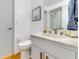 Bathroom featuring white cabinets, marble countertop, and wood floors at 315 Sweet Bay Ave, New Smyrna Beach, FL 32168