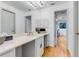 Bright bathroom features double sinks with quartz countertops and white cabinetry with gray trim and wood flooring at 315 Sweet Bay Ave, New Smyrna Beach, FL 32168