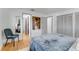 Bright bedroom featuring hardwood floors, a large bed, and access to the closet and other rooms at 315 Sweet Bay Ave, New Smyrna Beach, FL 32168