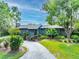 Charming home with lush landscaping, mature trees, and a unique stone chimney at 315 Sweet Bay Ave, New Smyrna Beach, FL 32168
