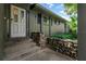 Charming front entrance features a stone retaining wall and inviting porch at 315 Sweet Bay Ave, New Smyrna Beach, FL 32168