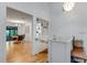 Bright hallway with wooden floors, white shiplap walls, and decorative built-in shelving leading to the dining area at 315 Sweet Bay Ave, New Smyrna Beach, FL 32168
