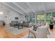 Bright living room with vaulted ceilings, hardwood floors, and large windows at 315 Sweet Bay Ave, New Smyrna Beach, FL 32168
