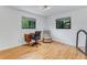 Bright office featuring hardwood floors, a vintage desk, and a comfortable chair perfect for working from home at 315 Sweet Bay Ave, New Smyrna Beach, FL 32168