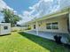 Back yard with covered patio, shed, and grass at 3303 Victory Palm Dr, Edgewater, FL 32141