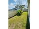Lush green back yard featuring a mix of grass, shrubbery and fencing at 3303 Victory Palm Dr, Edgewater, FL 32141