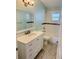 Bathroom featuring vanity sink with mirror and subway tiled tub with shower at 3303 Victory Palm Dr, Edgewater, FL 32141