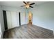 The bedroom features wood floors, a ceiling fan, closet, and an open doorway to the bathroom at 3303 Victory Palm Dr, Edgewater, FL 32141