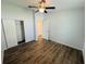 Bedroom featuring hardwood floors, ceiling fan, closet, and neutral paint at 3303 Victory Palm Dr, Edgewater, FL 32141