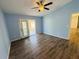 Serene bedroom with modern ceiling fan, light blue walls, and sliding glass doors opening to an enclosed patio at 3303 Victory Palm Dr, Edgewater, FL 32141