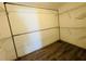 Walk-in closet with custom metal shelving and wooden laminate flooring. Ready for storage and organization at 3303 Victory Palm Dr, Edgewater, FL 32141
