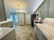 Bright kitchen with stainless steel appliances and spacious tile flooring and overhead lighting at 3303 Victory Palm Dr, Edgewater, FL 32141