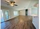 Open living room features wood flooring, natural light, and ceiling fan at 3303 Victory Palm Dr, Edgewater, FL 32141