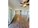 Spacious living room with wood flooring, ceiling fan, and natural light from the sliding glass doors at 3303 Victory Palm Dr, Edgewater, FL 32141