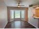 Living room area featuring hardwood floors, ceiling fan and bay window with natural light at 3303 Victory Palm Dr, Edgewater, FL 32141