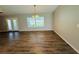 Bright, open-concept living space with sleek flooring, a large window, and access to the outdoor living space at 3303 Victory Palm Dr, Edgewater, FL 32141