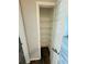 Pantry featuring metal shelving and laminate floors with white trim and door at 3303 Victory Palm Dr, Edgewater, FL 32141