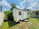 This exterior image shows a shed with a closed door on a clear day at 3303 Victory Palm Dr, Edgewater, FL 32141