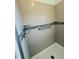 Modern shower with gray subway tile, glass accents, and grab bar at 3303 Victory Palm Dr, Edgewater, FL 32141