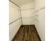 Bright walk-in closet with wood-look floors and multiple levels of white wire shelving for storage at 3303 Victory Palm Dr, Edgewater, FL 32141