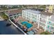 Aerial view of the complex featuring a courtyard pool, balconies, and convenient beach access at 3509 S Atlantic Ave # 102 And 103, New Smyrna Beach, FL 32169