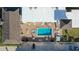 Aerial view showcases the pool, surrounding buildings, and parking areas of this property at 3509 S Atlantic Ave # 102 And 103, New Smyrna Beach, FL 32169