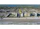 Aerial view of condo buildings with pool and beach access near a residential neighborhood at 3509 S Atlantic Ave # 102 And 103, New Smyrna Beach, FL 32169