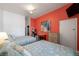 Inviting bedroom features twin beds, a vibrant accent wall, and modern amenities for a comfortable stay at 3509 S Atlantic Ave # 102 And 103, New Smyrna Beach, FL 32169
