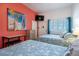 Comfortable bedroom with two beds, vibrant coral walls, and a flat-screen TV at 3509 S Atlantic Ave # 102 And 103, New Smyrna Beach, FL 32169