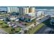 Exterior view of a condo complex featuring a parking lot and beach access at 3509 S Atlantic Ave # 102 And 103, New Smyrna Beach, FL 32169