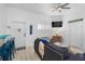 Comfortable living room with coastal accents, a flat-screen TV, and a view of the exterior through plantation shutters at 3509 S Atlantic Ave # 102 And 103, New Smyrna Beach, FL 32169