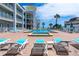 Relaxing pool deck with lounge chairs and turquoise umbrellas, inviting guests to unwind in style at 3509 S Atlantic Ave # 102 And 103, New Smyrna Beach, FL 32169
