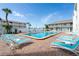 Inviting community pool area with comfortable lounge chairs and well-kept landscaping at 3509 S Atlantic Ave # 102 And 103, New Smyrna Beach, FL 32169
