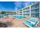 Large community pool surrounded by lounge chairs, tables, and well-maintained grounds at 3509 S Atlantic Ave # 102 And 103, New Smyrna Beach, FL 32169