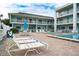 Inviting poolside area with comfortable lounge chairs and a refreshing pool for tenants to enjoy at 3509 S Atlantic Ave # 102 And 103, New Smyrna Beach, FL 32169