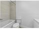 Bright bathroom featuring a shower-tub combo and neutral-toned tiling at 3610 Donna St, Port Orange, FL 32129