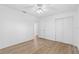 Bedroom featuring wood-look floors, ceiling fan, closet, and a doorway to other rooms at 3610 Donna St, Port Orange, FL 32129