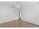 Bright bedroom featuring wood-look floors, ceiling fan, and a double door closet at 3610 Donna St, Port Orange, FL 32129