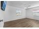 Bedroom featuring wood-look floors, ceiling fan, and natural light from two windows at 3610 Donna St, Port Orange, FL 32129