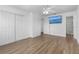 Bright bedroom with wood-look floors, ceiling fan, closet, and an en-suite bath at 3610 Donna St, Port Orange, FL 32129
