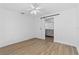 Bedroom featuring a modern barn door, ceiling fan, and light wood-look flooring at 3610 Donna St, Port Orange, FL 32129