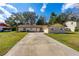Charming single-story brick home with a well-manicured lawn and a long driveway leading to an attached garage at 3610 Donna St, Port Orange, FL 32129