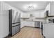 Modern kitchen with stainless steel appliances, white cabinets, and sleek backsplash at 3610 Donna St, Port Orange, FL 32129