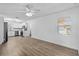 Bright living room with white walls, vinyl wood floors, and an open layout to the updated kitchen at 3610 Donna St, Port Orange, FL 32129